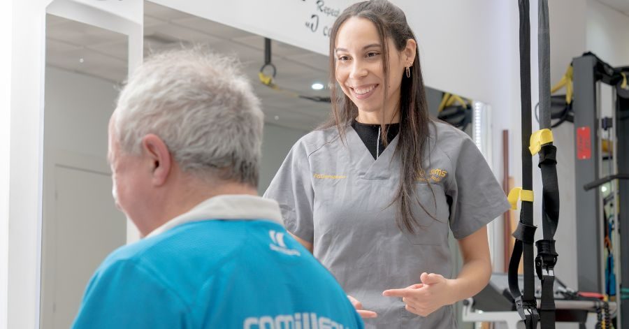 Paciente realizando ejercicio terapéutico para el dolor crónico guiado por fisioterapeuta