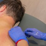 persona dandose masaje en Bio Ems clínica de fisioterapia en Alicante